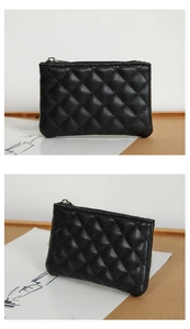 Close-up of black quilted PU leather coin purse with classic stitching and metal zipper