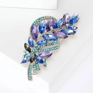 Detailed view of silver wheat brooch featuring sparkling blue and purple crystals