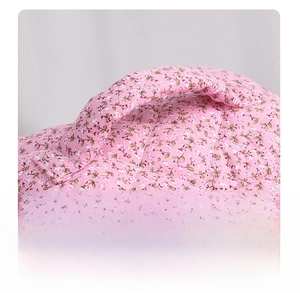 Detail of reinforced handles on a pink floral quilted travel makeup bag for storage