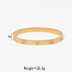 Detailed close-up of 6mm gold bangle with star engravings and square cubic zirconia stones