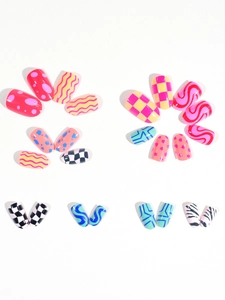 Flat lay of colorful oval press-on nails with patterns like polka dots and checkerboard