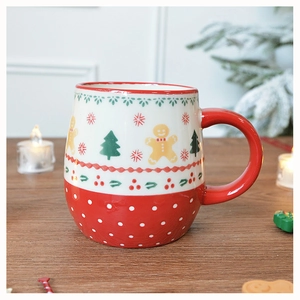 Close-up of ceramic Christmas mug with gingerbread man pattern on a wooden table
