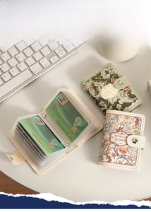 Detail shot of vintage floral card holder with multi-card slots and snap button closure
