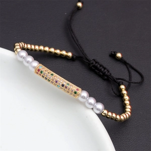 Detail of adjustable woven bracelet with colorful zircon inlay and copper beads