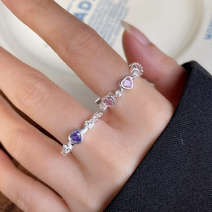 Close-up of 925 silver ring featuring heart-shaped purple gems and beaded texture details