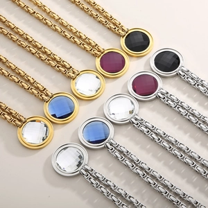 Close-up of multicolored crystal pendants on gold and silver stainless steel chains