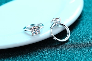 Macro detail of 925 sterling silver hoop earrings with four-prong round moissanite setting