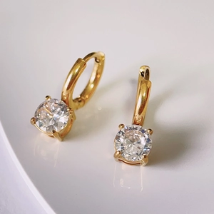 Close-up of 18k gold plated titanium hoop earrings with sparkling cubic zirconia drops