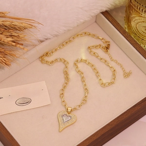 Two-tone heart cross pendant necklace with sparkling micro-pave zircons and gold chain