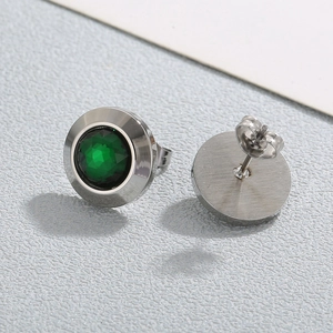 Macro shot of green faceted crystal stud earrings with polished silver stainless steel backs
