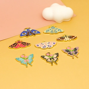 Set of 8 colorful moth and butterfly enamel charms on a stylish pastel background