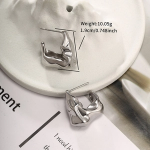 Detail of silver lava texture hoop earrings with size and weight measurements