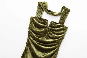 Detailed flat lay of velvet dress featuring square neckline and pleated texture