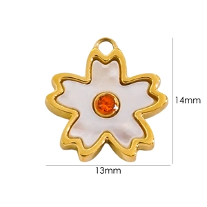 Macro detail of a 14k gold plated cherry blossom pendant with white petals and orange stone