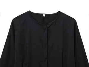 Close-up of black crew neck top with hidden placket and size S label on neckline