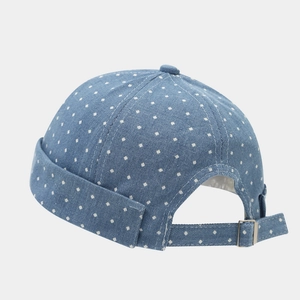 Detail of light blue denim miki hat with white polka dots and adjustable metal strap