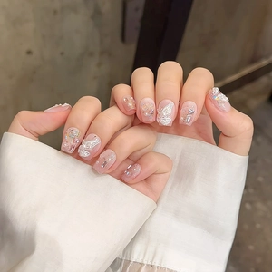 Handmade press-on nails featuring 3D white butterfly accents and pink purple gradients