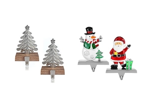 Close-up of metal Christmas stocking holders with snowman, Santa, and tree designs