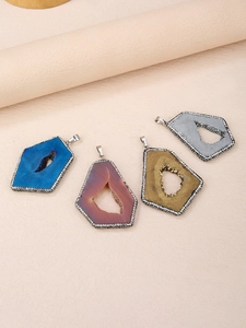 Detailed view of irregular agate geode pendants with sparkling rhinestone edges