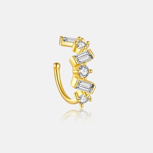 Detailed macro view of a gold S925 silver ear cuff with rectangular and round cubic zirconia