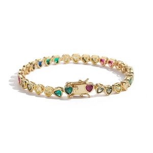 Close-up of colorful heart-cut zircons set in a gold-plated copper tennis bracelet