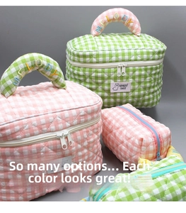 Detailed view of quilted plaid makeup bags with Melody embroidery and Lucky Day label