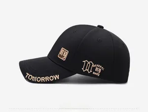 Detailed side view of black baseball cap featuring golden NY embroidery and side patterns