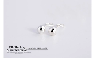 Detailed view of 990 sterling silver ball studs with high mirror polish finish