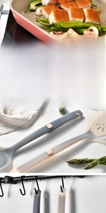 Detailed view of silicone spatula with built-in rest and ergonomic handle in usage