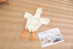 Detailed view of soft unstuffed white goose plush toy skin lying on wooden floor