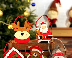 Christmas felt gift bags featuring Santa, Reindeer and Snowman in a warm festive setting