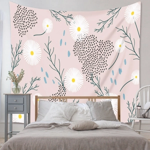Detail of bohemian tapestry featuring white daisy floral pattern on a soft pink background