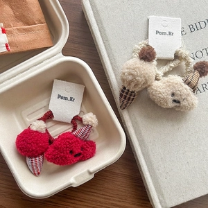 Cute lamb wool plush ice cream hair scrunchies in red and beige displayed on a wooden table