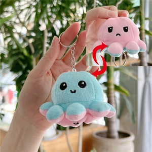 Detailed view of reversible octopus plush showing the flip feature from blue to pink