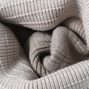 Thick beige ribbed knit beanie for men and women showing warm textured fabric detail