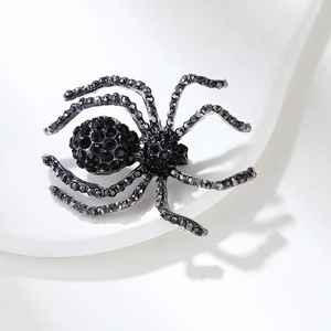 Close-up of a vintage spider brooch with sparkling black rhinestones and intricate details