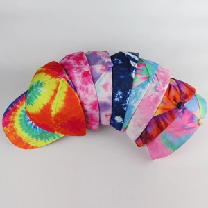 Top view of eight colorful graffiti tie-dye baseball caps in cotton fabric stacked together