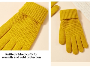Detail view of yellow knit gloves showing elastic ribbed cuffs and honeycomb texture