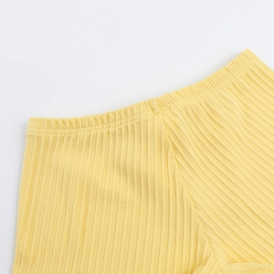 Detail view of the yellow corduroy elastic waistband on summer casual two-piece romper