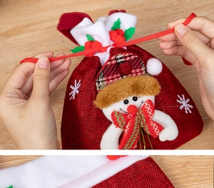 Detail of red burlap Christmas drawstring gift bag with 3D snowman and plush trim