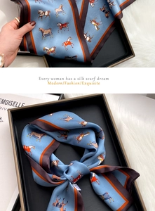 Detail of silk scarf with equestrian horse print and two-tone border design