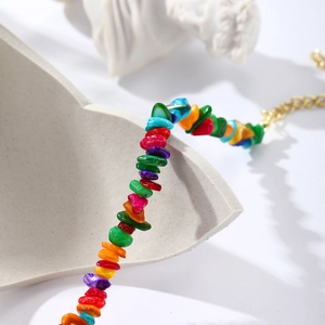 Detailed shot of bohemian colorful gravel beads with adjustable gold lobster clasp