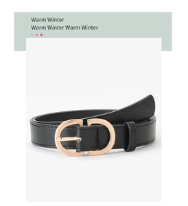 Detail of black leather belt featuring a polished gold metal buckle in CD shape