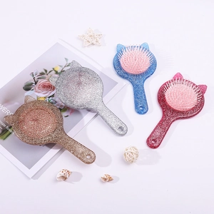 Detail of four colorful cat-ear massage hairbrushes with glitter finish and air cushions