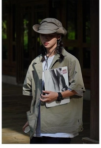Detail of khaki outdoor bucket hat with adjustable drawstring in gorpcore style