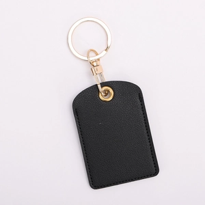 Detail of a black leather key fob holder with gold ring for access control cards