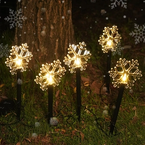 Solar powered snowflake garden stake lights with warm LED glow for outdoor Christmas decor