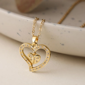 Golden double heart pendant necklace with shimmering zircon stones on a fine O-chain