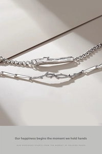 Macro shot of silver couples bracelets with thorn and branch texture details