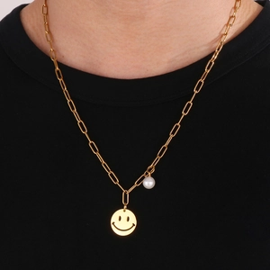 Golden stainless steel paperclip necklace with a smiley face pendant and pearl accent